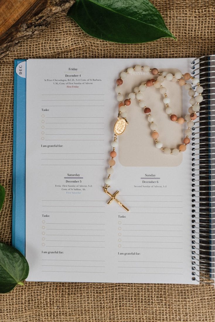 A weekly page with a rosary laid across it